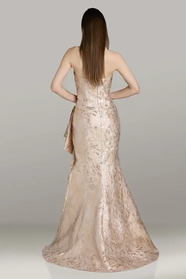 model is wearing a strapless fit and flare champagne mothers dress