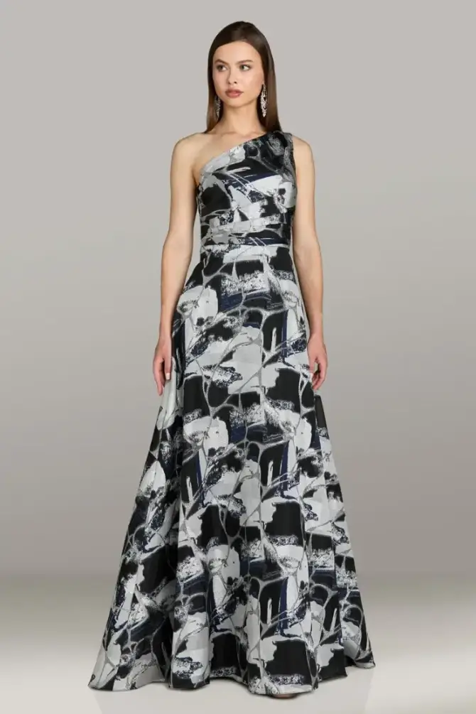 model is wearing a one shoulder black and grey/white evening gown