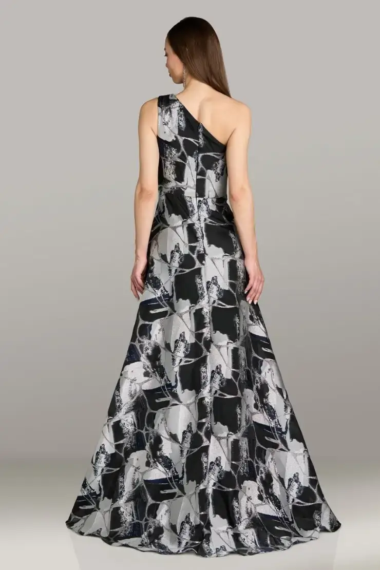 model is wearing a one shoulder black and grey/white evening gown