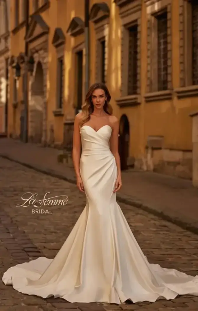 model is wearing a strapless fit and flare bridal gown