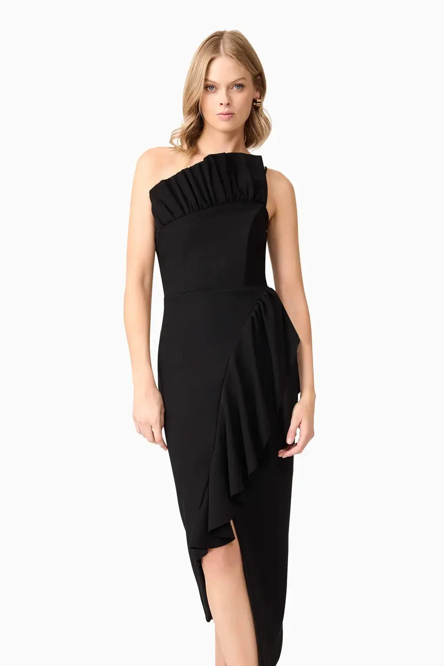 Model is wearing a sleek black midi dress with a frill high neckline, asymmetrical hemline, and a body-contouring fit that transitions effortlessly from dinner to the dance floor.